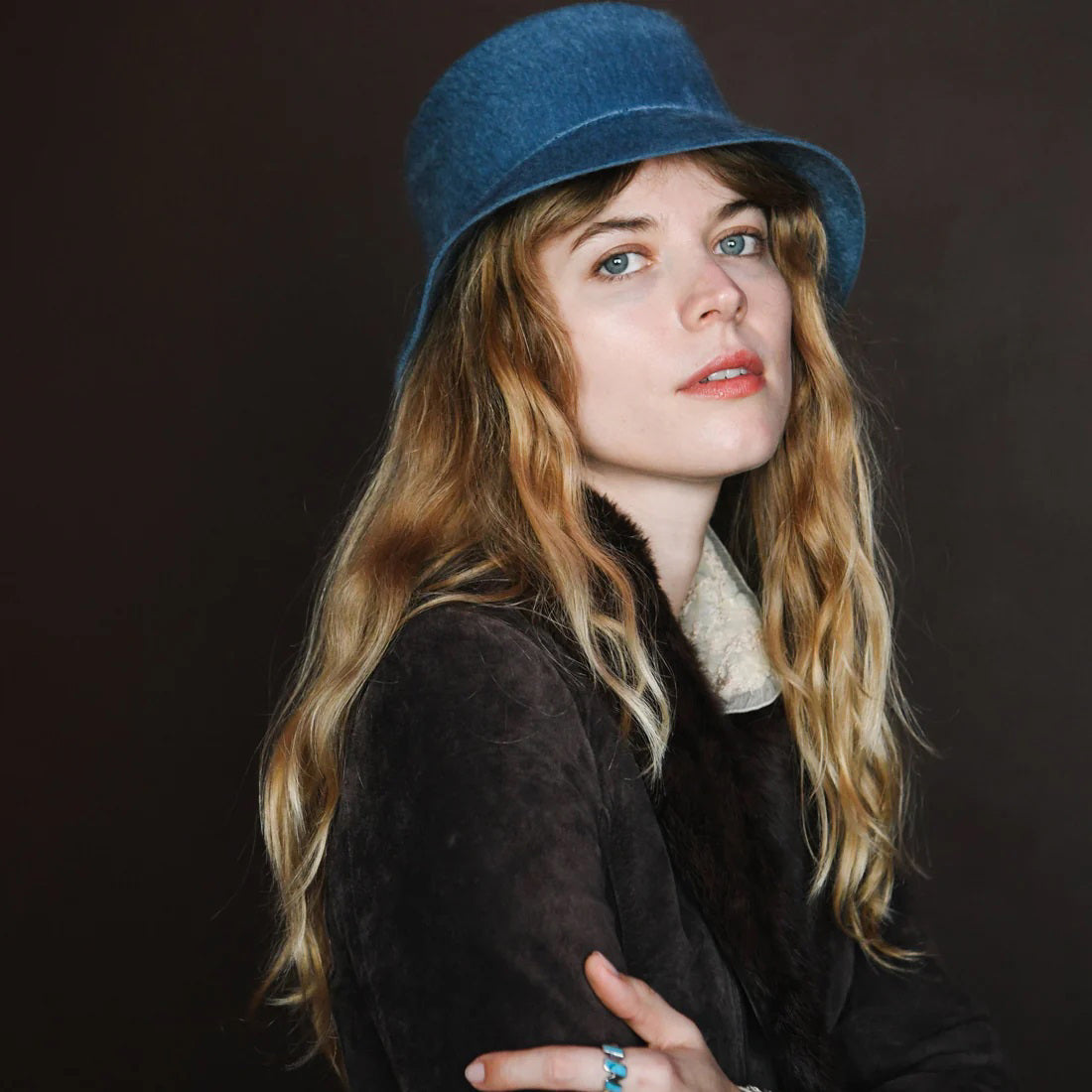 WYETH's TENLEY BUCKET HAT, a blue bucket hat made from fuzzy mohair wool and featuring a wide brim, is presented against a simple white background.