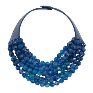 The FAIRCHILD BALDWIN - THE BELLA NECKLACE showcases layered strands of iridescent green Italian resin beads with a faceted design for a shimmering effect, finished with a smooth light green clasp that complements its vibrant hues.