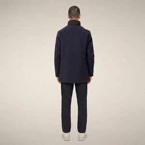 A man wears a dark blue SAVE THE DUCK - BLAISE JACKET IN BLUE BLACK with a high neck and a zippered chest pocket.