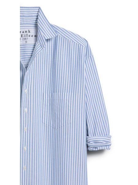 The FRANK &amp; EILEEN Finbar men's button-up shirt in blue stripe oxford features light blue and white vertical stripes, a chest pocket, rolled-up sleeves, and breathable Italian oxford cotton, shown from the chest up against a white background.