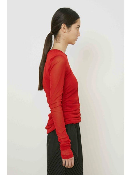 A close-up of MEIMEIJ&#39;s MESH LAYERING TOP in brown shows its subtle diagonal weave and fine fibers—perfect for a minimalist look.