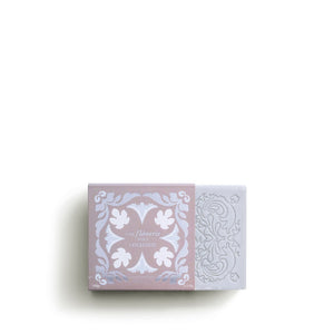 The ROSE ET MARIUS "A Stroll Under the Oratory" scented soap gift box features a decorative bar of artisanal soap, partially slid from its pink and white floral-patterned packaging, inspired by Provence.