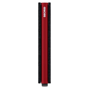 The SECRID - SLIMWALLET MATTE IN BLACK AND RED is shown closed and standing upright, with striking red stitching and a red accent on the side. A small lever is visible at the bottom. This RFID-protected wallet from SECRID offers a sleek design combined with practical security for your everyday essentials.