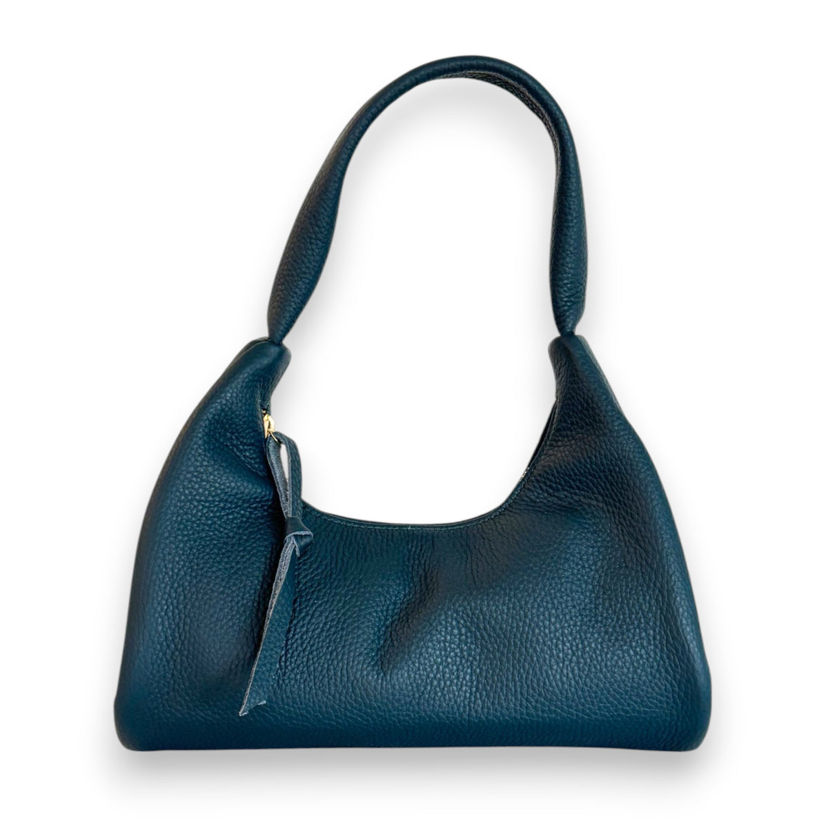 The OLIVEVE Gia Baguette in Mediterranea Italian Buffalo Cowhide is a stylish dark green handbag with a structured crescent shape, single curved handle, and zipper closure. Ethically made in the USA, it features a small tag against a plain white background.