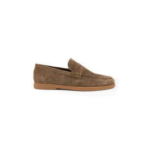 COLLARS AND CO's Sigaro Penny Loafers in dark tobacco suede are men's slip-on loafers with low heels, rubber soles, and a decorative strap across the top, shown against a white background.