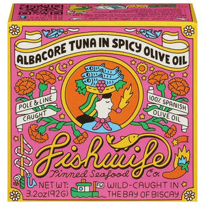 An open can of FISHWIFE - WILD CAUGHT SPICY ALBACORE TUNA, showing large, light brown pieces packed in oil or sauce, against a plain white background.