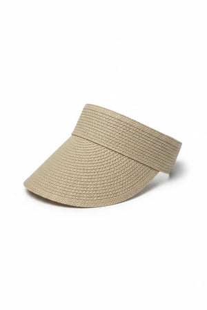 A woman with long, light brown hair wears the BEACH HARE - JUNIE VISOR by BEACH HARE and a mauve sleeveless top, looking to her right against a plain light background. The visor is handmade in NY.