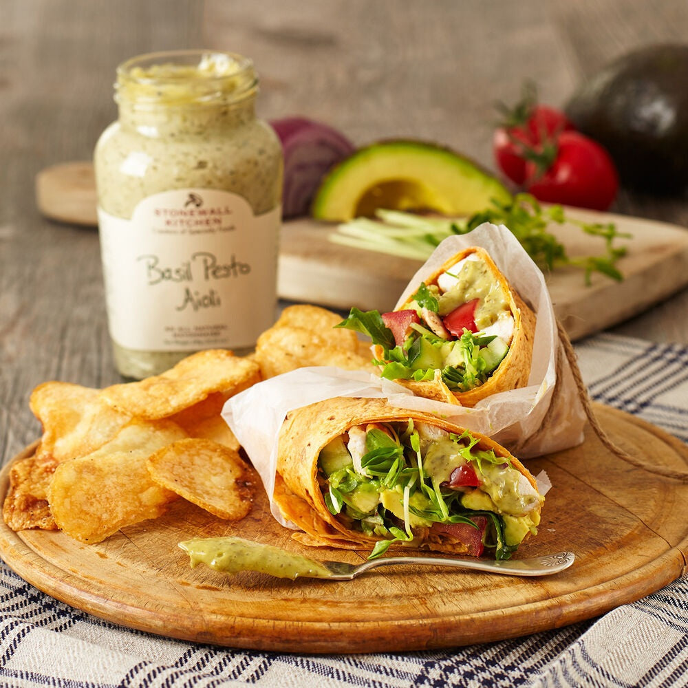 A glass jar of STONEWALL KITCHEN - BASIL PESTO AIOLI with a green lid features a white label displaying the product name, gluten-free notation, and 291g (10.25 oz) net weight. This French mayo-inspired aioli is perfect as a dip for vegetables, a spread for sandwiches, or to add flavorful basil pesto taste to your favorite dishes.