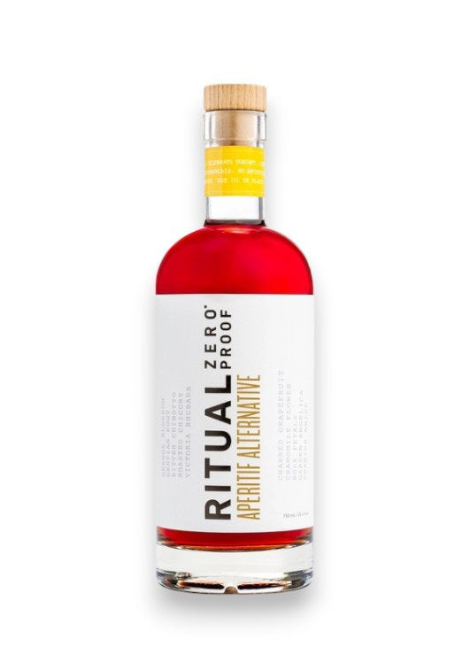 A clear glass bottle of Ritual Zero Proof Aperitif Alternative, featuring vibrant red liquid and a white label with bold black and yellow text—perfect for making a refreshing non-alcoholic spritz or Italian aperitivo.