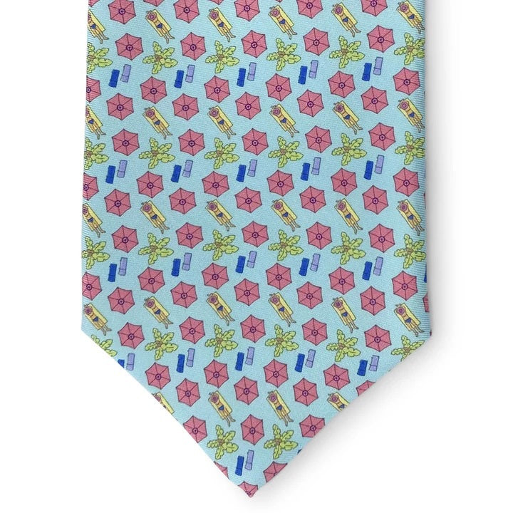 The BIRD DOG BAY PETER-BLAIR - SUNSCREEN SILK TIE IN AQUA showcases a lively print of pink beach umbrellas, green palm trees, and blue rectangles on an aqua silk background. Rolled neatly on a white surface, this playful accessory is handmade in New York and finished with the iconic Peter-Blair woven label.