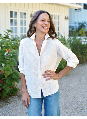 Introducing the FRANK & EILEEN - EILEEN Relaxed Button Up in Italian Cotton Textured Natural Flowers: a long-sleeve, button-up white shirt with a subtle floral texture, rolled cuffs, and a pointed collar. Designed for a relaxed fit, this shirt is crafted from premium Italian cotton and features thoughtfully placed buttons to flatter the bust for an effortlessly stylish silhouette. The signature label inside reads “FRANK & EILEEN EST 1947.”.