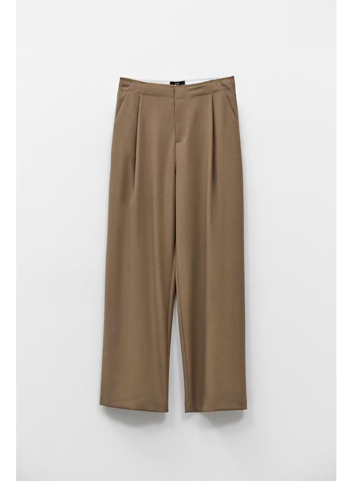 ELEH - TROUSER IN MUD GREY by ELEH: These mud grey, high-rise tailored trousers feature front pleats and a wide-leg silhouette that finishes at the ankle. The trousers are shown against a plain white background.