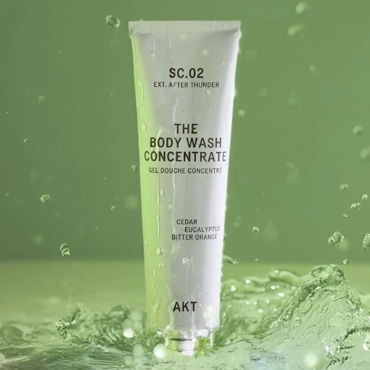 A partially squeezed purple tube labeled AKT London, featuring “BODY WASH CONCENTRATE AFTER THUNDER,” highlights long-lasting use—one tube lasts up to 3 months. Packaged in 100% recyclable aluminum with zero plastic, this vegan, plastic-free body wash offers a powerful and concentrated 3x formula with no added water.