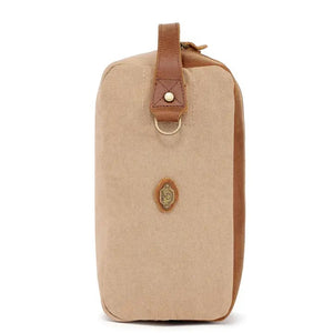 The TSD BRAND - VALLEY OAK TOILETRY BAG IN KHAKI is a handcrafted toiletry bag with a handle, shown open from above to reveal its empty beige fabric-lined interior—perfect for organized travel.