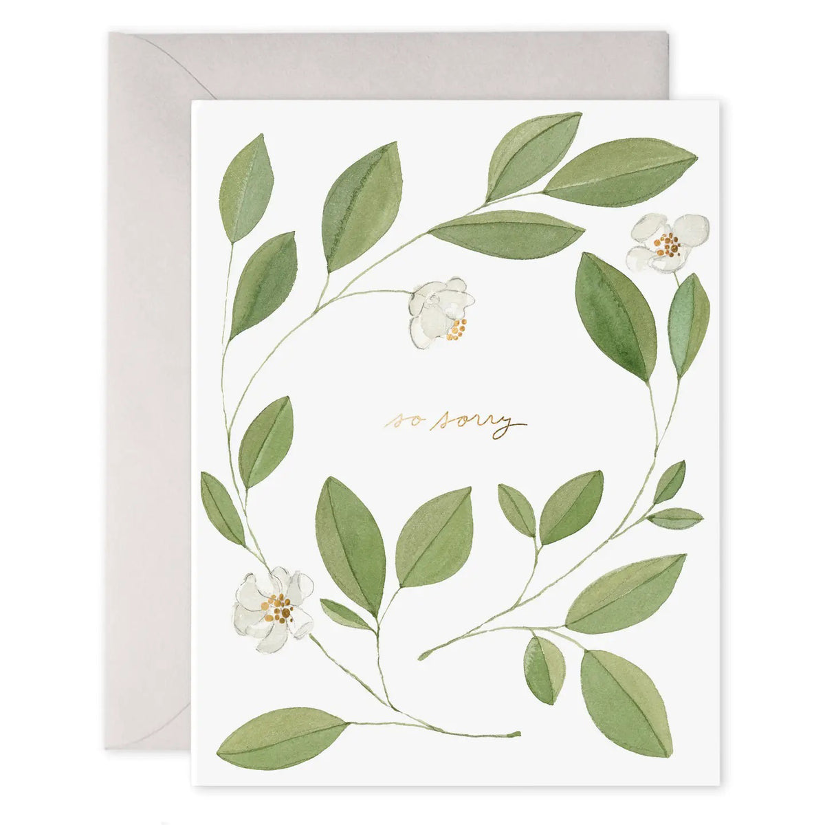 The E. FRANCES PAPER Magnolia Condolence Card features "so sorry" in elegant gold cursive, framed by a wreath of green magnolia leaves and white flowers, and includes a beige envelope.
