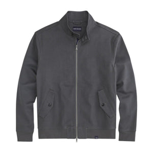 The MACK WELDON Twill Harrington Jacket in Asphalt is a dark gray cotton cavalry twill zip-up with a stand collar, two angled button-flap pockets, ribbed cuffs and hem, offering an English jacket style. Shown on a black background.