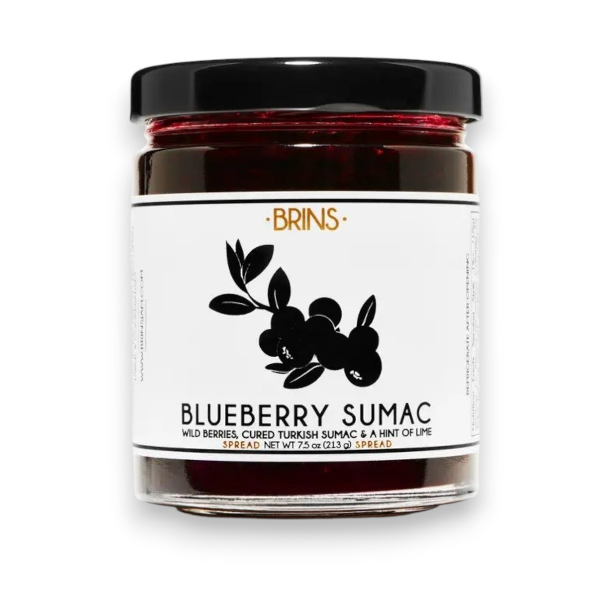 A jar of BRINS WILD BLUEBERRY SUMAC SPREAD, distinguished by its black lid and a white label adorned with illustrations of blueberries and leaves. The label emphasizes wild blueberries, single origin spices such as Turkish sumac, and the inclusion of lime.