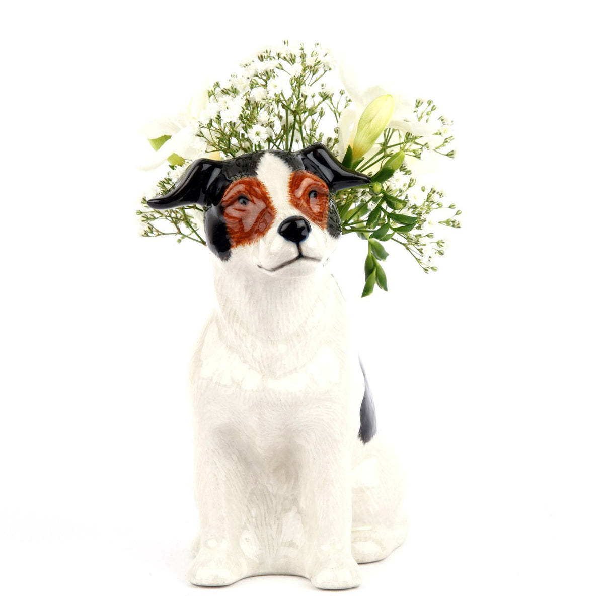 The QUAIL CERAMICS - JACK RUSSELL FLOWER VASE SMALL by QUAIL DESIGNS is a hand-painted stoneware figurine of a black and white dog with brown facial details, sitting and facing right.