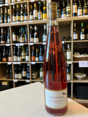 A tall, clear bottle of RED TAIL RIDGE ROSÉ 2024 from WINE: OCEAN SOUTH IMPORTS—this dry rosé shows a deep pink-red hue. The bottom label features the brand name and product information.