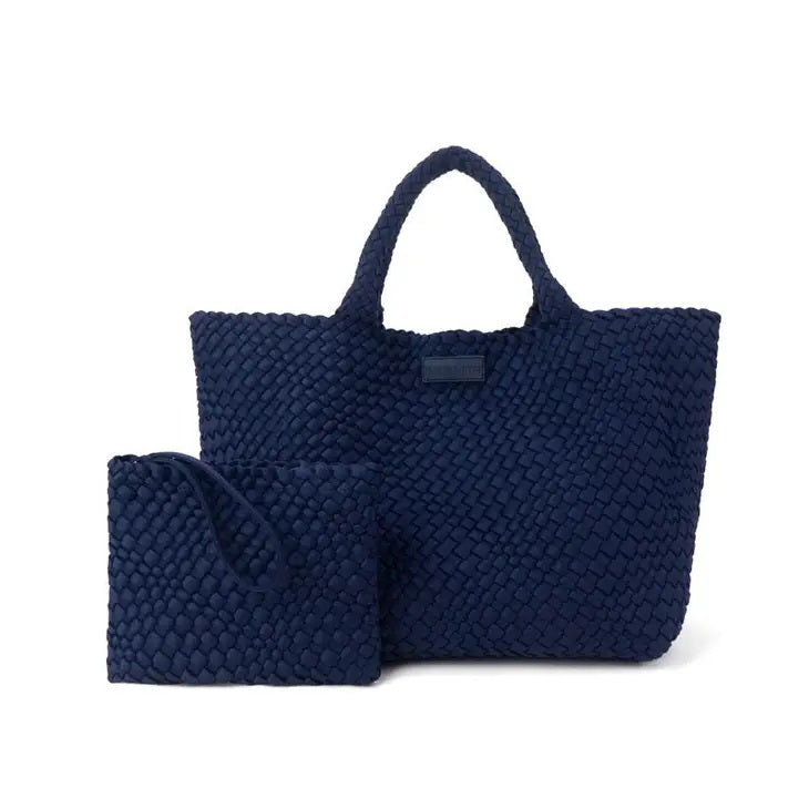 The PARKER &amp; HYDE Oversized Woven Tote Bag is a hand-woven black tote with a matching pouch, both featuring a subtle crisscross pattern. The versatile tote has short handles and a sturdy texture, while the pouch includes a convenient zipper closure.