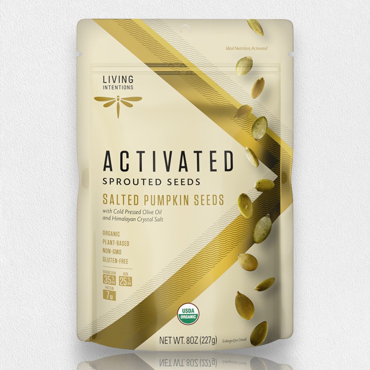 A beige packet labeled &quot;LIVING INTENTIONS - SALTED PUMPKIN SPROUTED SEEDS&quot; contains salted pumpkin seeds. The bag highlights its organic, plant-based, non-GMO, and gluten-free attributes, along with USDA-organic certification and a net weight of 8oz. Graphics of sprouted pumpkin seeds and a hint of Himalayan salt adorn the side.