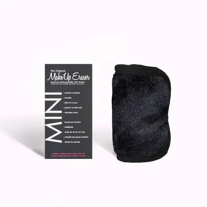 A black, rectangular MAKEUP ERASER MINI PRO BLACK ERASER labeled &quot;MINI&quot; beside its packaging. The MAKEUP ERASER is water-activated, reusable for 3-5 years, machine-washable, and perfect for sensitive skin.