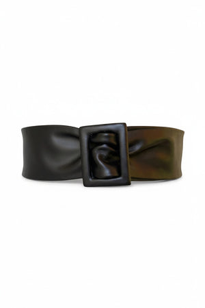 The APROPOS BELT by ADA is a handcrafted brown leather belt with a wide band and smooth texture. Made from genuine Argentinian leather, it features a rectangular buckle, showcased on a plain white background.
