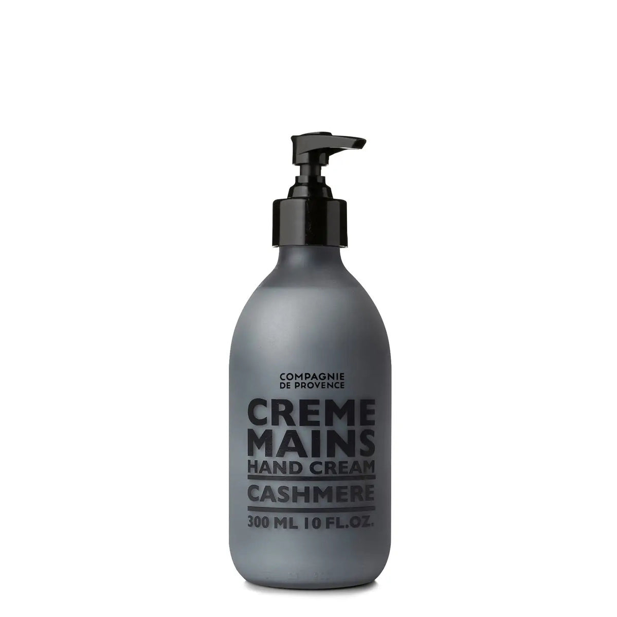 A grey bottle with a black pump, labeled &quot;CIE LUXE BRANDS COMPAGNIE DE PROVENCE CASHMERE HAND CREAM,&quot; contains shea butter and woody, spicy notes; it holds 300 ml (10 fl oz).