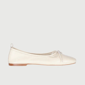 The Augusta - Sienna Ballet Flat by AUGUSTA is a single silver-colored shoe featuring a subtle metallic sheen and a simple bow on the front. It has a low brown sole and a pull tab at the back. Handcrafted in Spain from leather, this ballet flat is shown from the side against a light gray background.