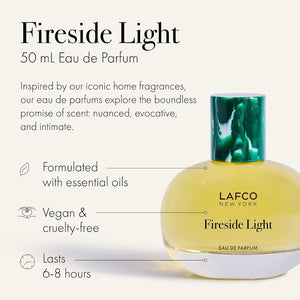 A round glass bottle of LAFCO Fine Fragrance, Fireside Light 50ml, a vegan perfume with a long-lasting scent, contains yellow liquid and is topped with a marbled green cap, displayed against a plain white background.