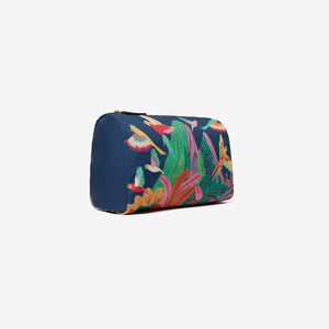 The INOUI EDITIONS - RIO NYLON CASE, MEDIUM by INOUI is a zippered pouch featuring a vibrant Rio illustration with colorful birds and lush greenery on a dark blue background. Birds in various flying poses bring dynamic movement to this chic travel accessory.