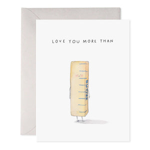 The E. Frances Paper "More Than Butter" greeting card features a whimsical watercolor of a butter stick with tiny arms and legs. "LOVE YOU MORE THAN" text adorns the top, and it comes with a light gray envelope, proudly made in the USA.