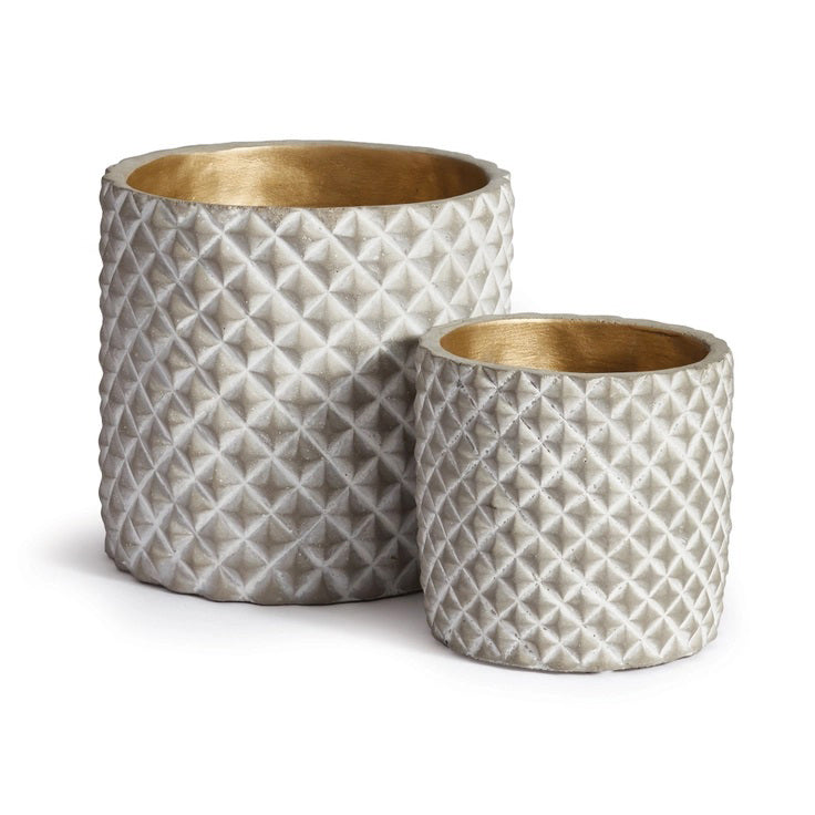 Two round NAPA HOME AND GARDEN quilted pots in textured gray with metallic gold interiors are elegantly arranged, the larger one positioned behind and to the left of the smaller, against a plain white background, evoking Napa California's chic style.