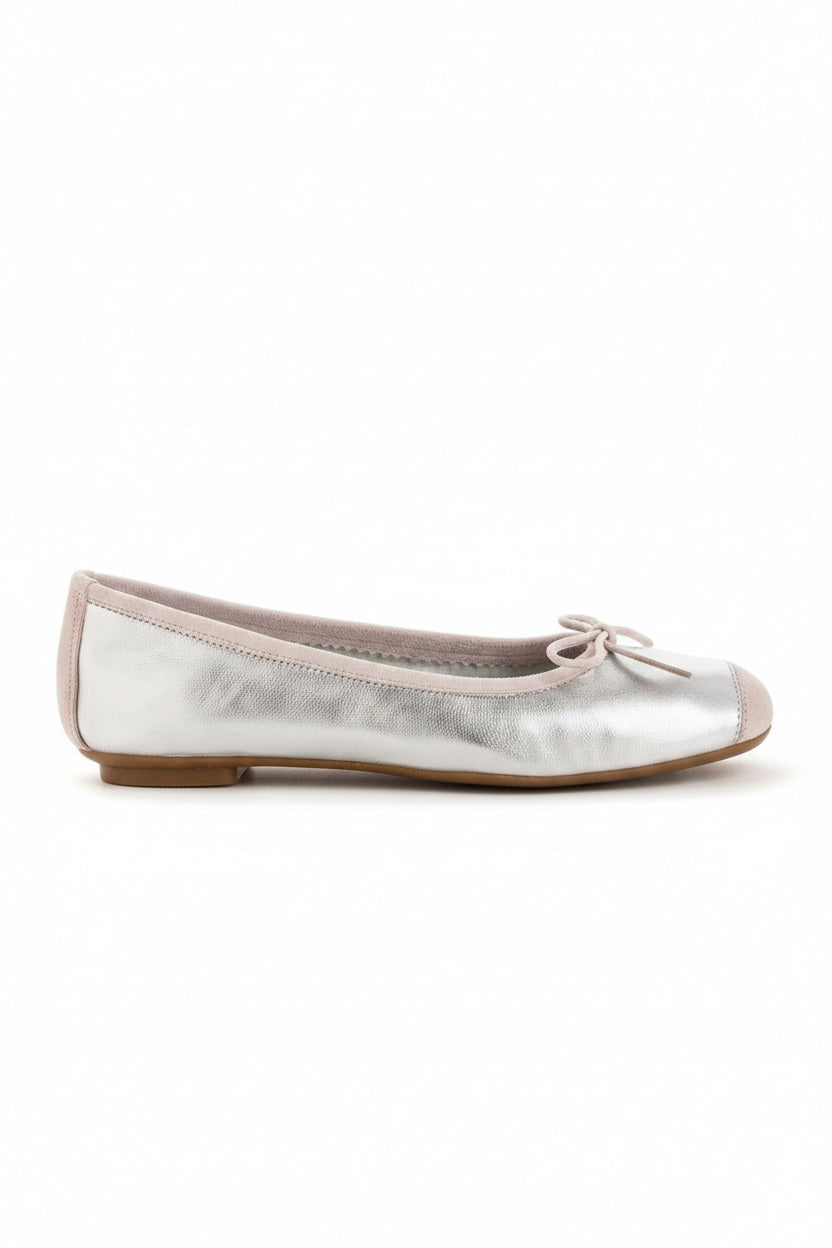 Top view of the REQINS - HARMONY BALLERINA FLATS IN METALIC SILVER by REQINS, featuring shimmering silver leather and a front bow, captured on a plain light background for a chic metallic look.