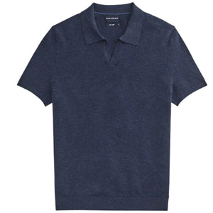 A close-up of a person’s arm and torso wearing the MACK WELDON Tech Linen Johnny Collar Polo Sweater in Navy Heather, paired with light gray pants featuring a buttoned pocket.