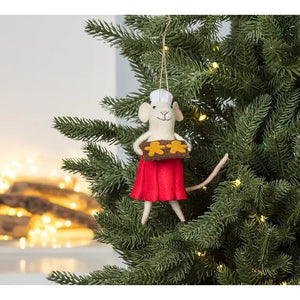 An ABBOTT PASTRY CHEF MOUSE felt ornament wearing a red skirt and holding a cookie tray, hanging on a Christmas tree.