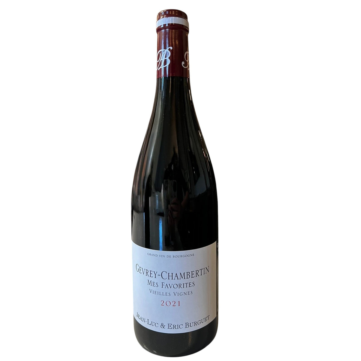 A bottle of ALAIN BURGUET ‘MES FAVORITES’ GEVREY CHAMBERTIN 2021 red wine with a white label featuring the text “Mes Favorites,” “Vieilles Vignes,” “2021,” and the names “Jean-Luc & Eric Burguet.”