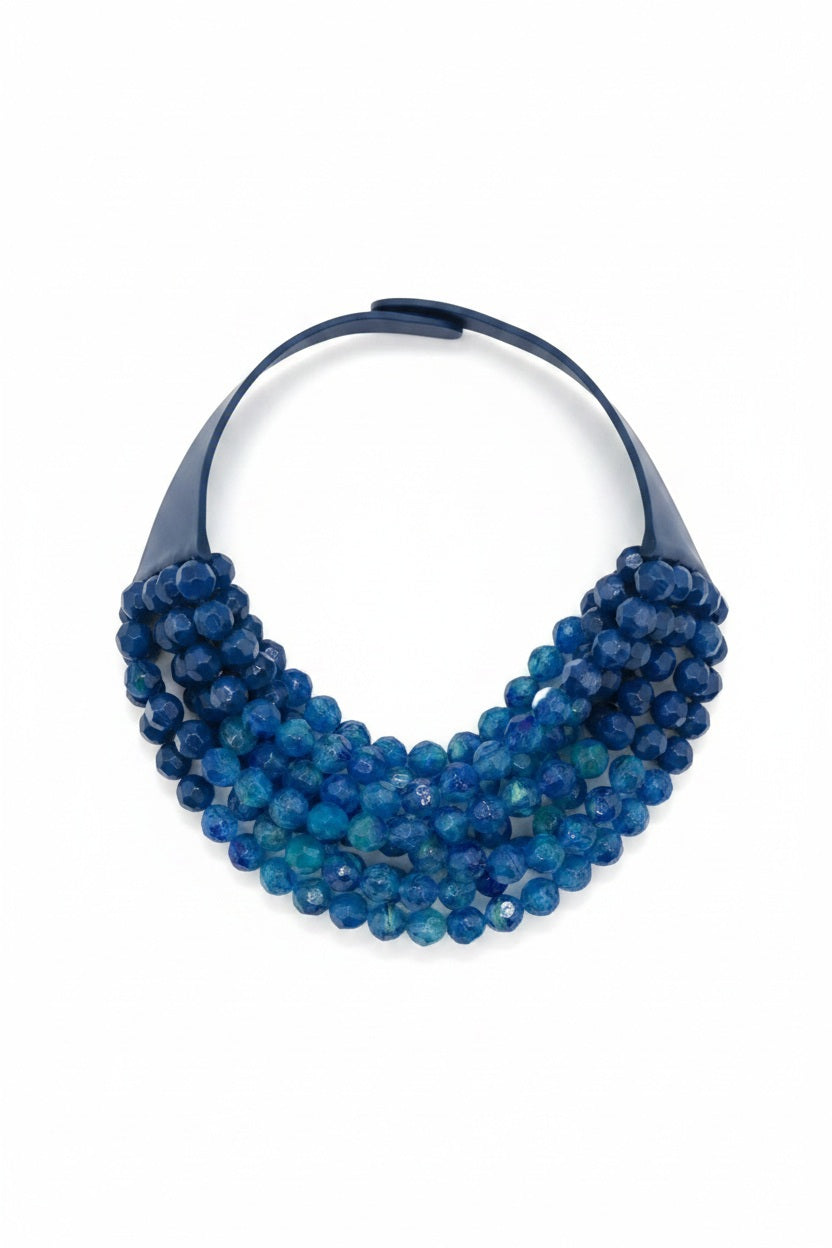 The FAIRCHILD BALDWIN - THE BELLA NECKLACE showcases layered strands of iridescent green Italian resin beads with a faceted design for a shimmering effect, finished with a smooth light green clasp that complements its vibrant hues.