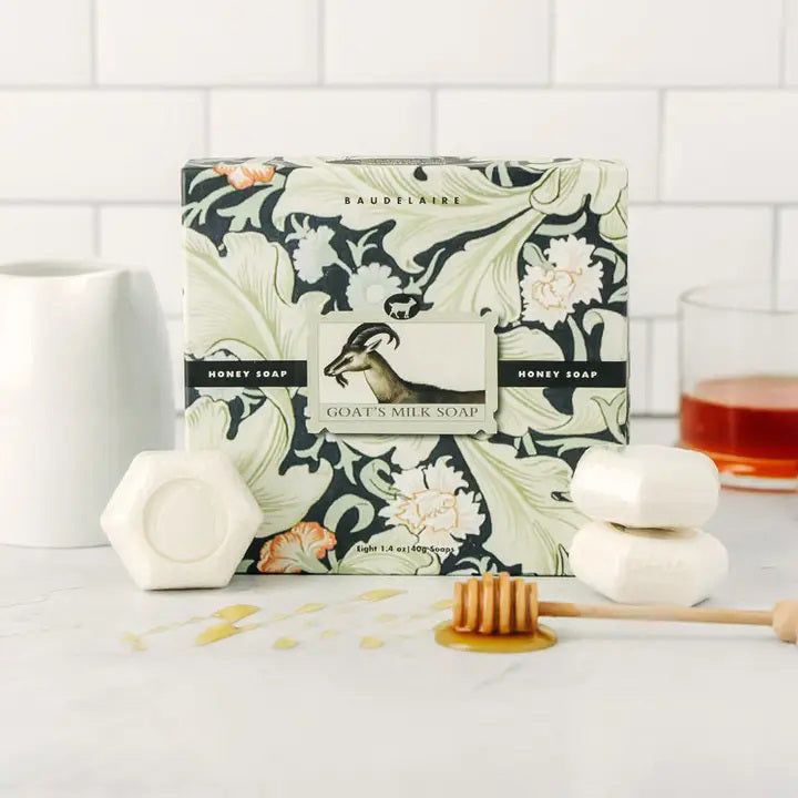 The BAUDELAIRE GOATS MILK HONEY SOAP 1.4OZ GIFT BOX includes eight hexagonal moisturizing soaps for sensitive skin in a vintage floral and bird-adorned box, offering classic charm and gentle care.