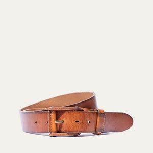 A close-up of the WILL LEATHER GOODS - LEATHER BUCKLE BELT by WILL LEATHER GOODS, featuring brown full-grain leather with a natural texture and slightly worn look, plus a gold metal buckle, displayed diagonally on a white background.