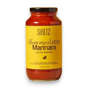A jar of SAUZ Summer Lemon Marinara, featuring a vibrant yellow label with “Zesty Citrus Tomato Sauce,” showcases bold, savory flavors made from locally-sourced ingredients.