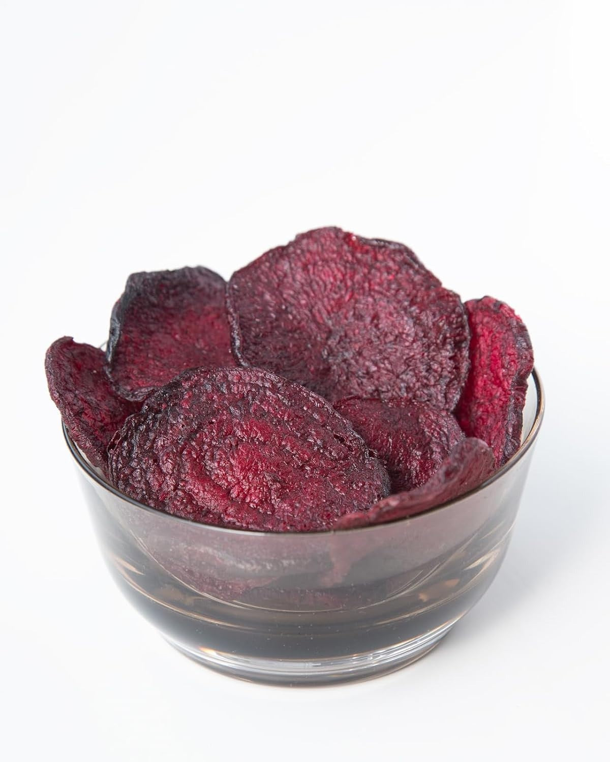 Three whole beets beside a plus sign, a bag of ROOT FOODS - BEET CHIPS, and three crunchy veggie chips. Text reads: “It takes 6 fresh beets to make 1 bag of ROOT FOODS - BEET CHIPS.” Blue background. Made by ROOT FOODS with avocado oil for a delicious crunch.