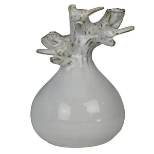 The HOMART CERAMIC VASE WITH BRANCH AND BIRD features white flowers and branches, set on a wooden surface with framed bird art and a woven basket against a light gray textured wall for a cozy touch.