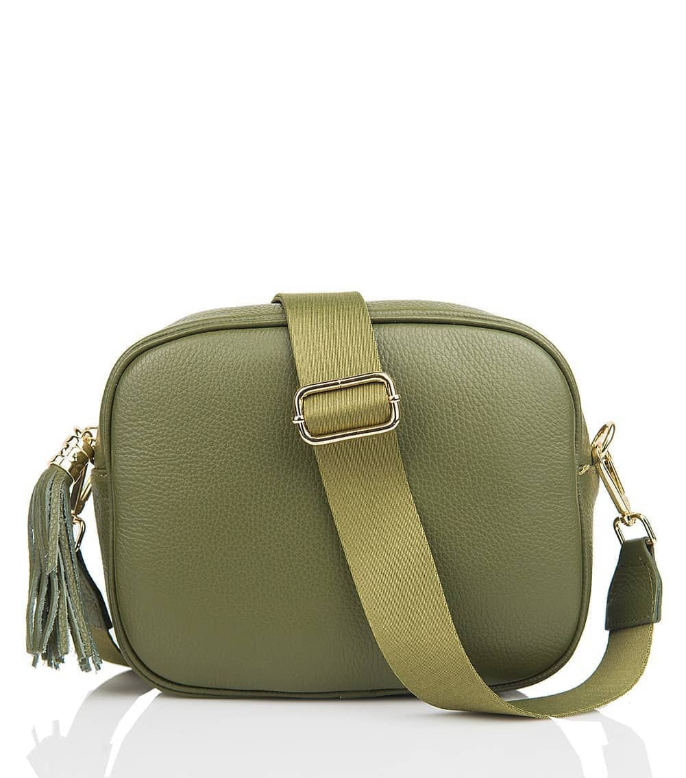 The LE BORSETTE leather crossbody bag is shown in green, showcasing a rectangular shape. It features a wide, adjustable green strap with a gold buckle and clasp. The bag is equipped with a gold zip closure and complemented by a green tassel pull. Made from genuine leather, it is placed against a white background.
