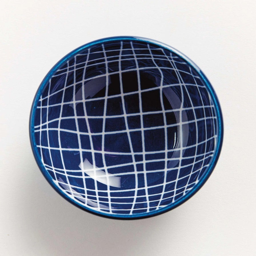 The NAPA HOME AND GARDEN Blue and White Stria Dip Bowl features a blue grid pattern and sits on a matching large white plate, both adding modern style to your table. Dishwasher safe, this tableware is perfect for entertaining.