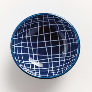 The NAPA HOME AND GARDEN Blue and White Stria Dip Bowl features a blue grid pattern and sits on a matching large white plate, both adding modern style to your table. Dishwasher safe, this tableware is perfect for entertaining.