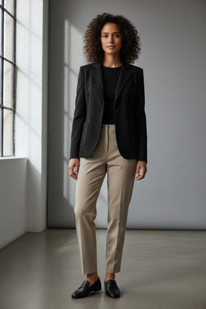 The SEVENTY - SINGLE BREASTED KNIT JACKET by the brand SEVENTY is a tailored women's jacket in black, featuring classic lapels, a single-button closure, and two front pockets. It has a sleek, fitted design and a minimalist, professional appearance. The interior is lined with the "SEVENTY" label visible inside.