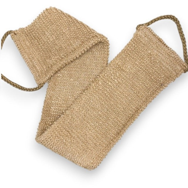A close-up of the SMILE BOUTIQUES NATURAL ORGANIC JUTE BACK SCRUBBER, featuring a brown, woven jute design with a braided handle at one end and laid flat on a white background—this handmade bath accessory offers a sustainable upgrade to your shower routine.