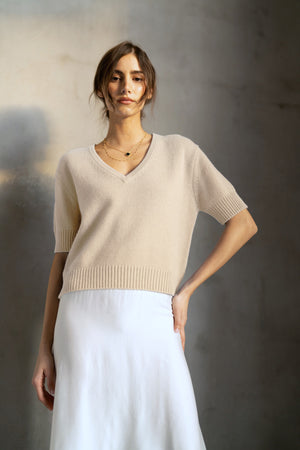 The ROSE & CROWN Cashmere Short Sleeve V Neck Sweater in deep red is shown on a white hanger against a plain white background.