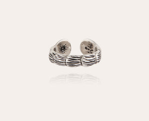 The GAS BIJOUX - SILVER LIANE JONC BIS RING, crafted by GAS BIJOUX, showcases a stunning bamboo motif with intricate engraved designs on the interior. It easily adjusts to fit you perfectly and is presented on a simple beige background with a delicate shadow beneath.